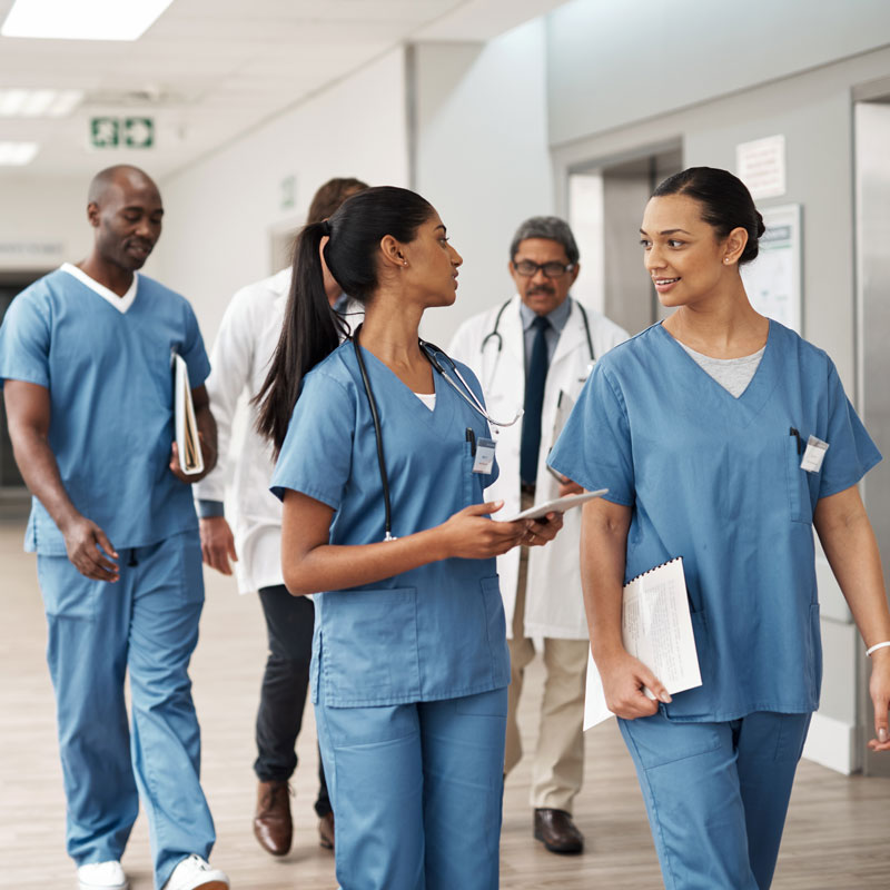 nurses and doctors walking down hallway